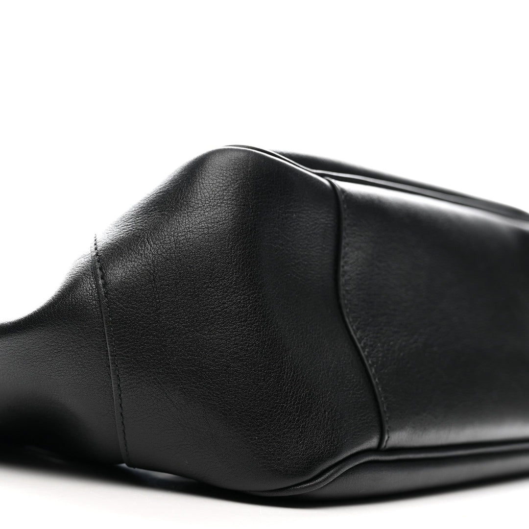 Close-up of a black leather seat on a white background