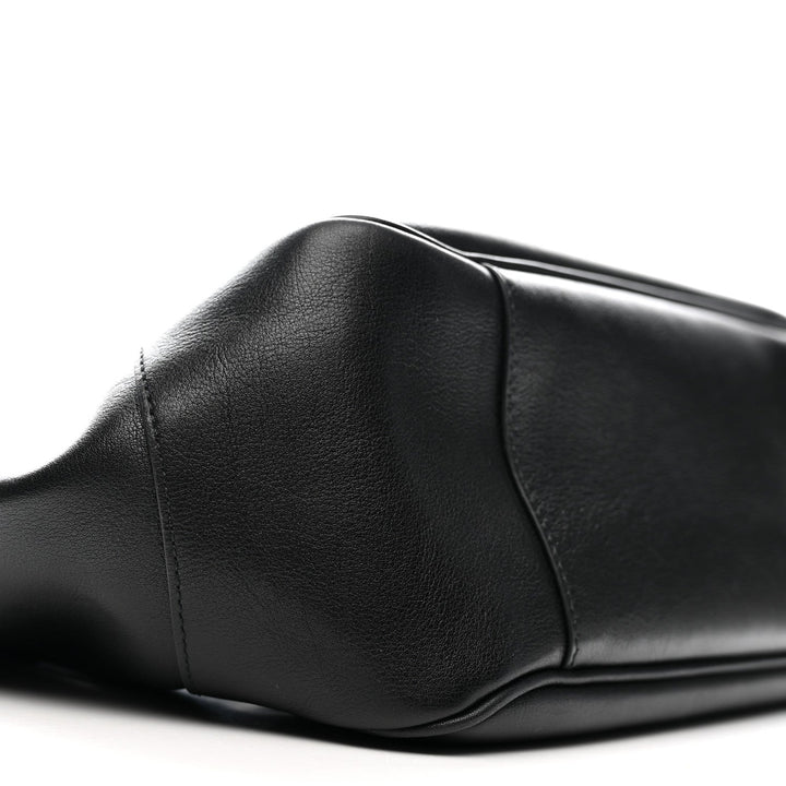 Close-up of a black leather seat on a white background