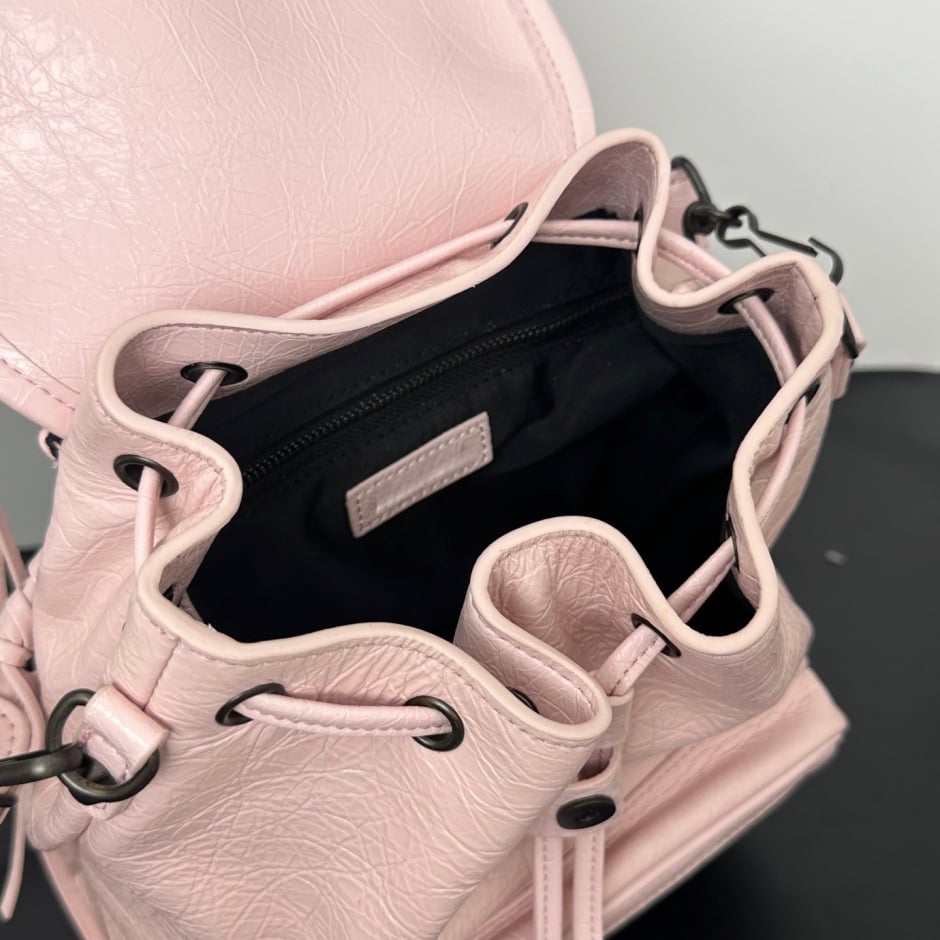 backpack close-up of black stud detailing and drawstring tabs