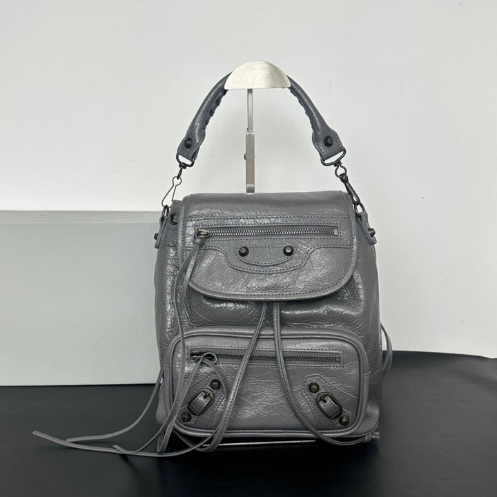 Namrico white leather biker style backpack close-up of black stud detailing and drawstring tabs