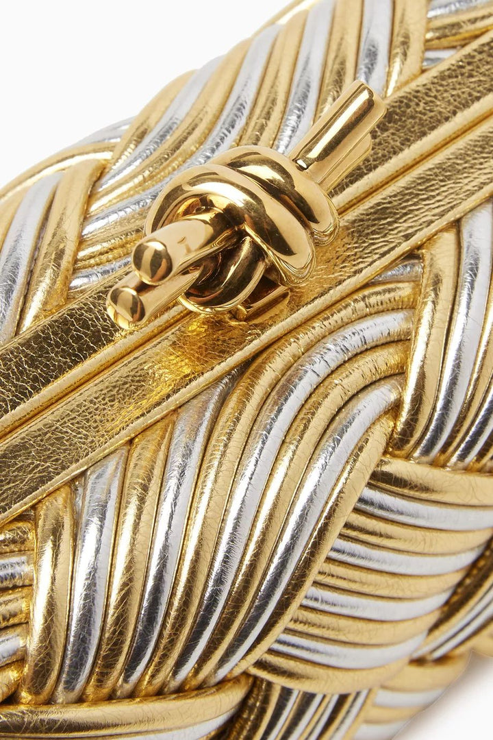 Close-up of a gold and silver braided bracelet
