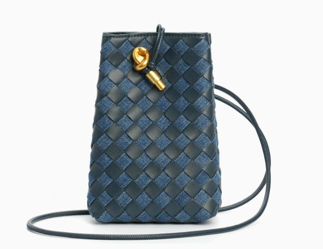Luxury woven leather mini crossbody bag in black with signature gold cylinder hardware