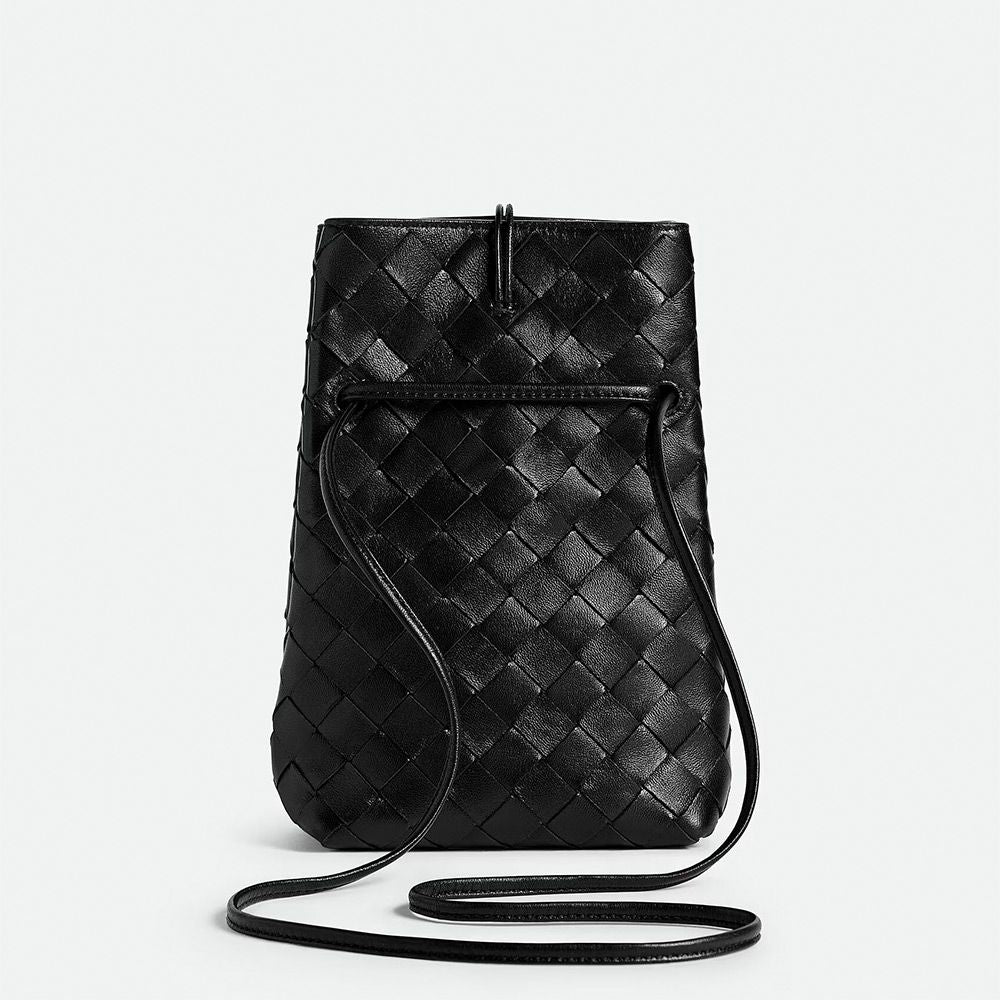 Black woven leather crossbody bag on a light gray background