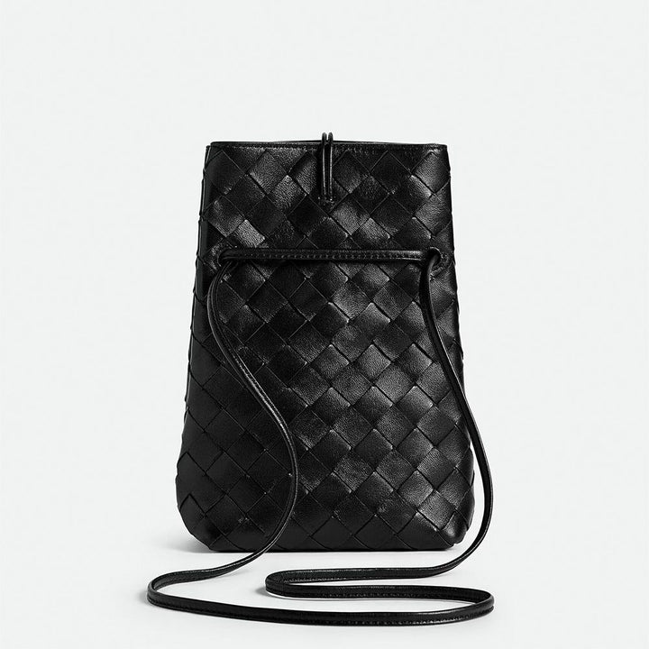 Black woven leather crossbody bag on a light gray background